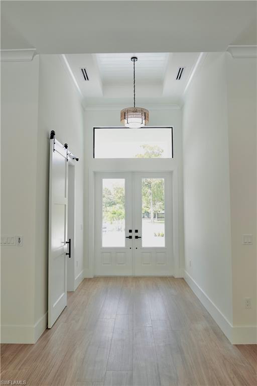 428 21st Street Southwest Naples, FL 34117 - Photo 12 of 45 a view of an empty room with wooden floor and a window