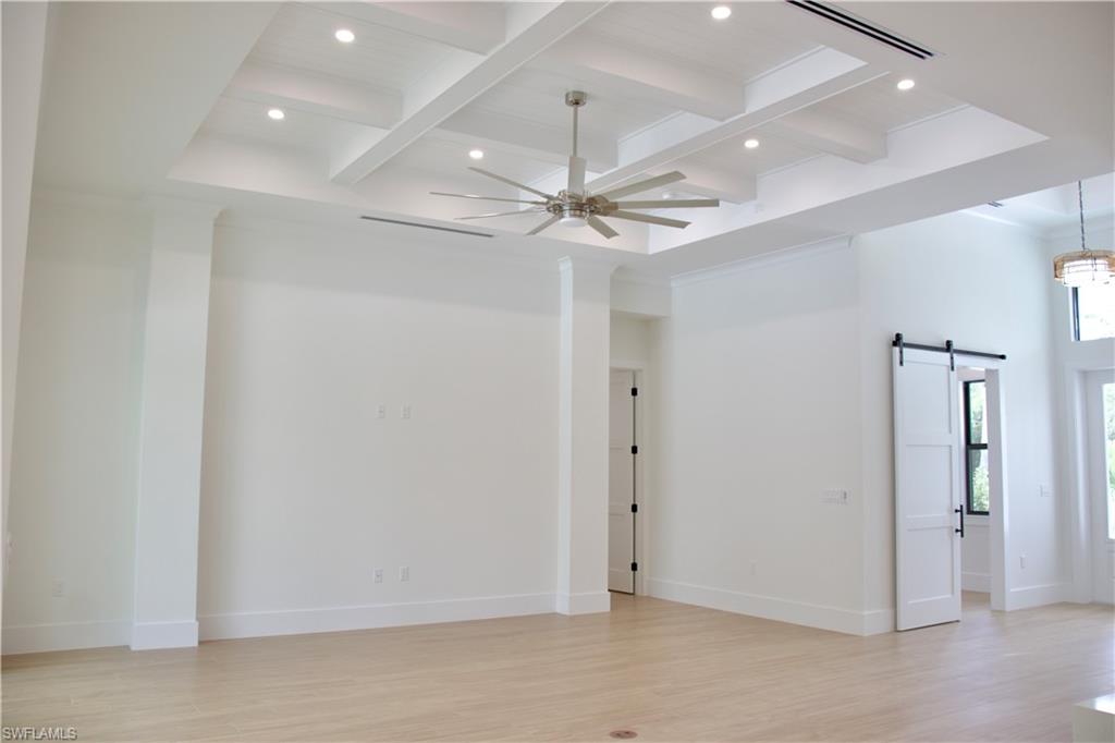 428 21st Street Southwest Naples, FL 34117 - Photo 15 of 45 en empty room with fan and a chandelier fan