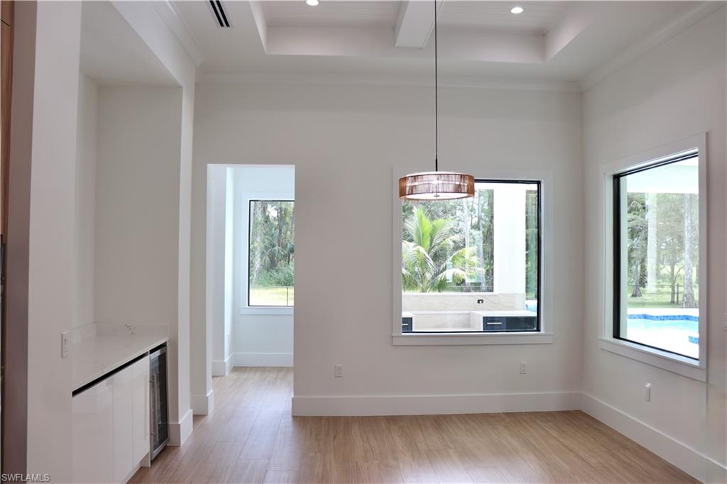 428 21st Street Southwest Naples, FL 34117 - Photo 22 of 45 a view of an empty room with wooden floor and a window