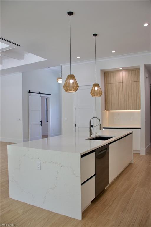 428 21st Street Southwest Naples, FL 34117 - Photo 25 of 45 a kitchen with stainless steel appliances granite countertop wooden cabinets a stove a sink and a wooden floors