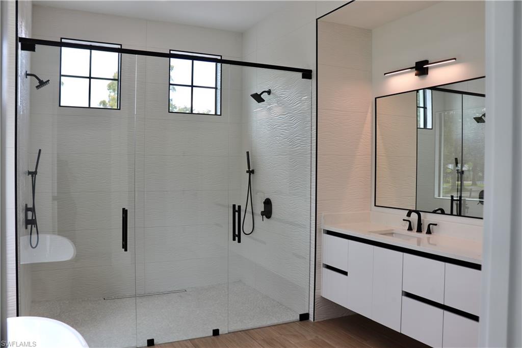 428 21st Street Southwest Naples, FL 34117 - Photo 26 of 45 a bathroom with a double vanity sink toilet and shower