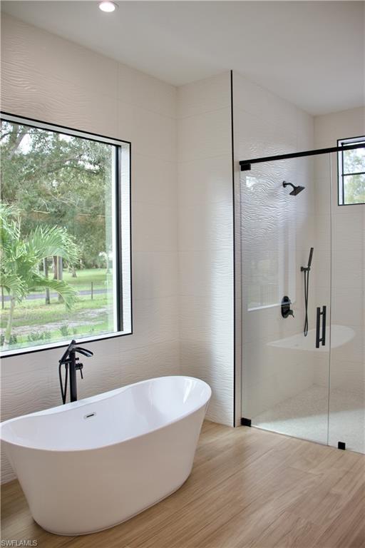 428 21st Street Southwest Naples, FL 34117 - Photo 27 of 45 a white bath tub sitting in a bathroom next to a window
