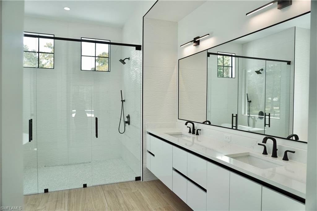 428 21st Street Southwest Naples, FL 34117 - Photo 28 of 45 a bathroom with double vanity and a mirror