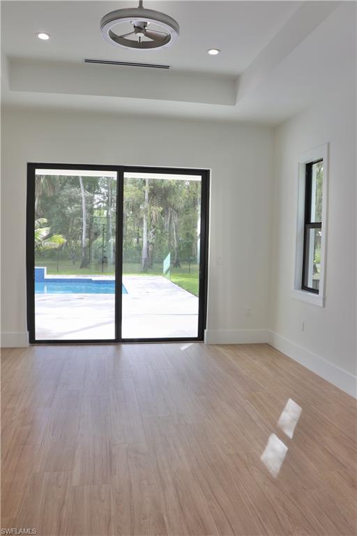428 21st Street Southwest Naples, FL 34117 - Photo 29 of 45 a view of an empty room with glass door and a window