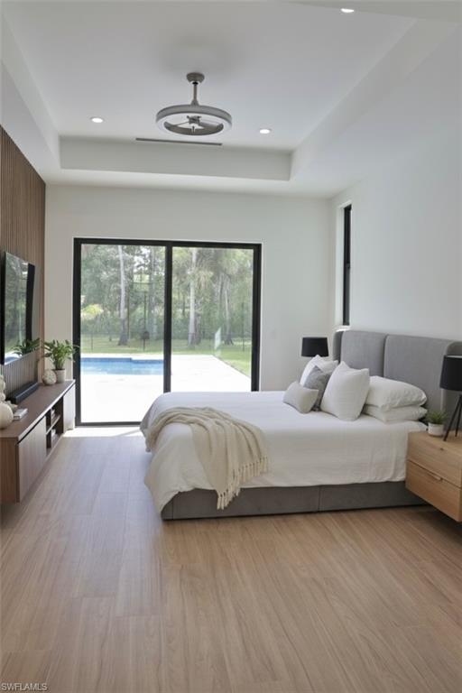 428 21st Street Southwest Naples, FL 34117 - Photo 30 of 45 a bedroom with a large bed and a flat tv screen on dresser