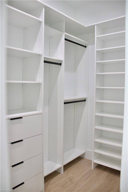 428 21st Street Southwest Naples, FL 34117 - Photo 32 of 45 a view of walk in closet with empty racks