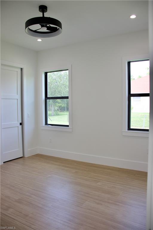 428 21st Street Southwest Naples, FL 34117 - Photo 33 of 45 a view of an empty room with wooden floor and a window