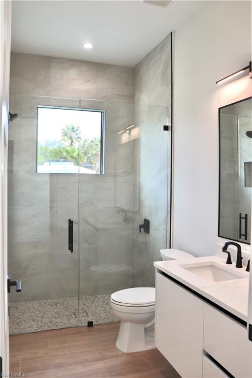 428 21st Street Southwest Naples, FL 34117 - Photo 35 of 45 a bathroom with a granite countertop sink a toilet and shower