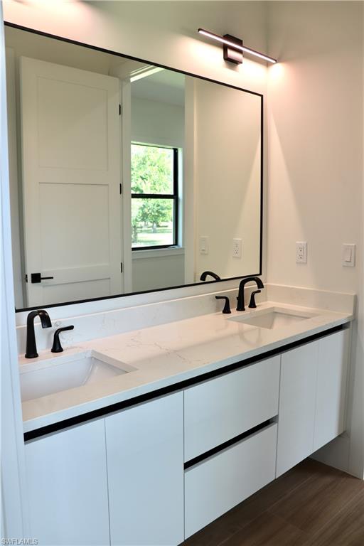 428 21st Street Southwest Naples, FL 34117 - Photo 36 of 45 a bathroom with a sink and a mirror