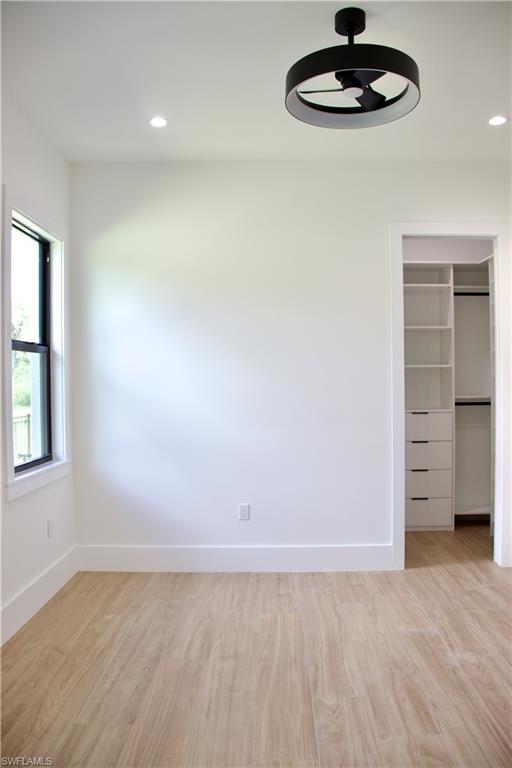 428 21st Street Southwest Naples, FL 34117 - Photo 37 of 45 an empty room with a empty space and chandelier fan