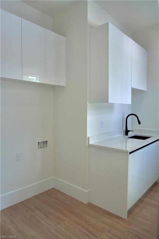 428 21st Street Southwest Naples, FL 34117 - Photo 41 of 45 a kitchen with a sink and cabinets