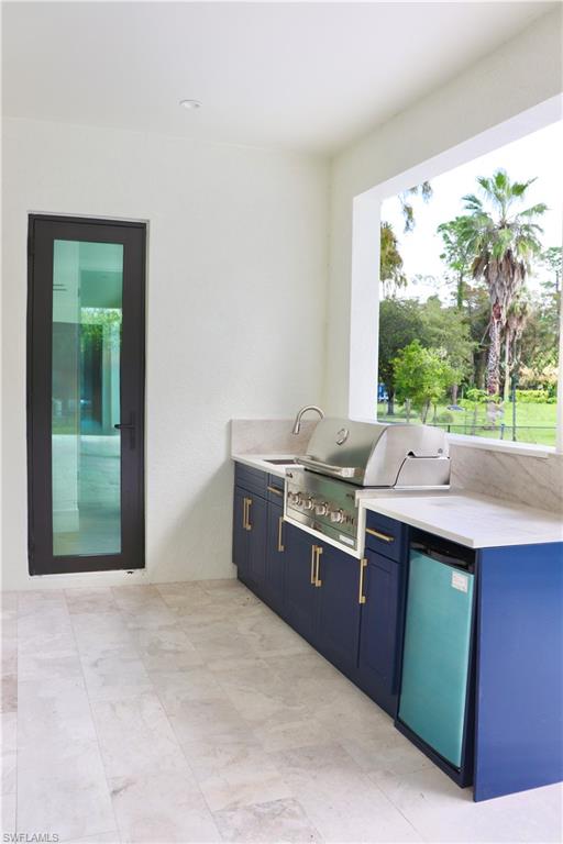 428 21st Street Southwest Naples, FL 34117 - Photo 42 of 45 a kitchen with granite countertop a sink window and cabinets