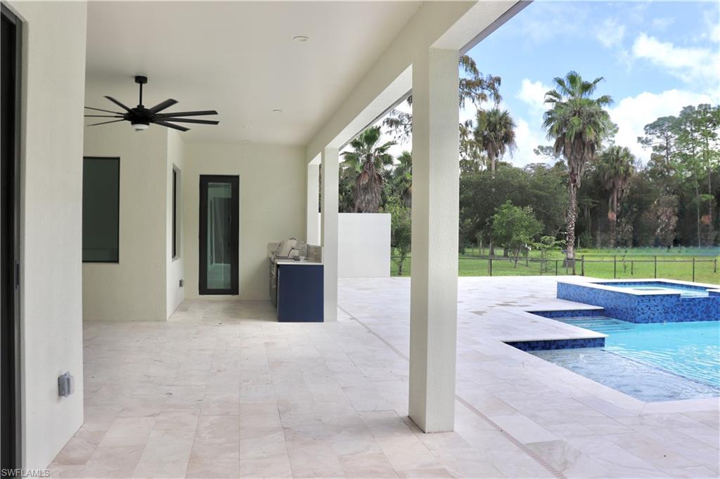 428 21st Street Southwest Naples, FL 34117 - Photo 44 of 45 a view of a house with backyard and a garden