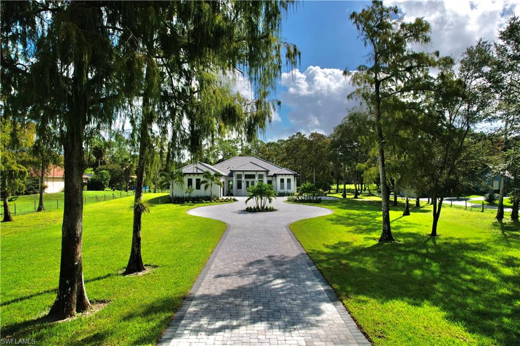 428 21st Street Southwest Naples, FL 34117 - Photo 5 of 45 a view of a park with large trees
