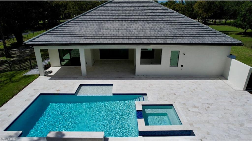 428 21st Street Southwest Naples, FL 34117 - Photo 7 of 45 a front view of a house with a yard