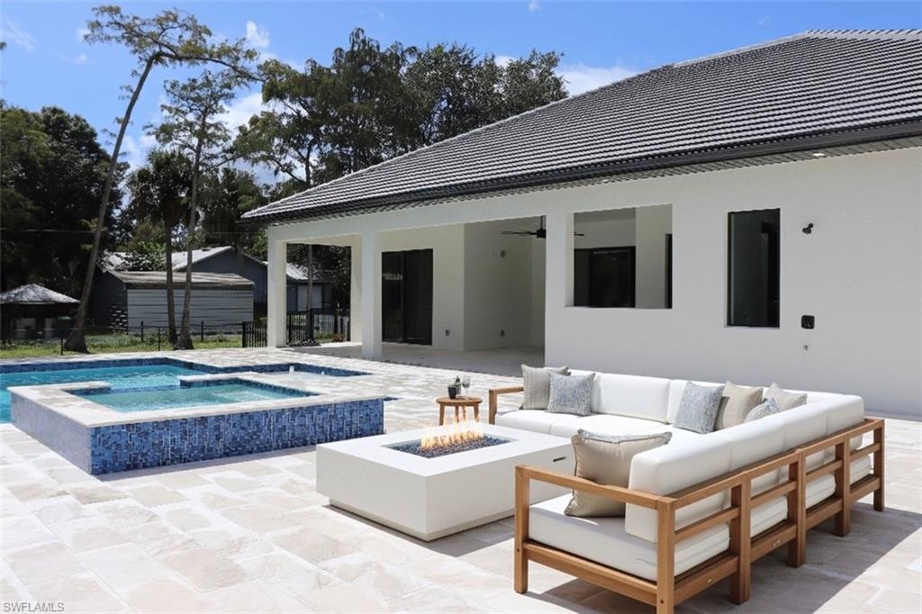 428 21st Street Southwest Naples, FL 34117 - Photo 9 of 45 a view of house with swimming pool and outdoor seating