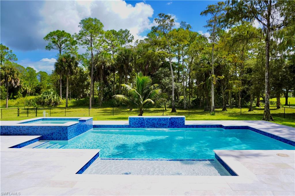 428 21st Street Southwest Naples, FL 34117 - Photo 10 of 45 a view of swimming pool with a yard