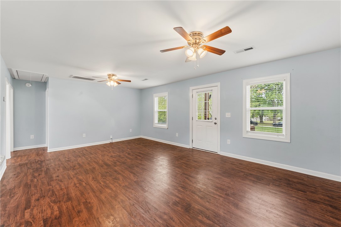 104 Leah Drive Pendleton, SC 29670 - Photo 8 of 23 This airy room features wood floors and bright windows, creating an inviting and open atmosphere.