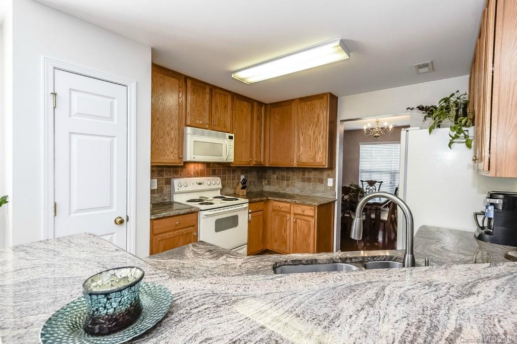7475 Fallen Timber Lane Tega Cay, SC 29708 - Photo 8 of 24 a kitchen with a sink stove and cabinets