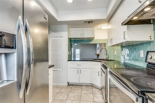 a kitchen with a sink stainless steel appliances and cabinets