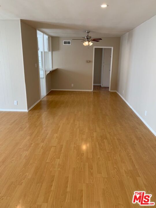 1201 South Sherbourne Drive, Unit 4 Los Angeles, CA 90035 - Photo 3 of 14 a view of empty room with wooden floor