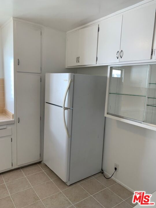 1201 South Sherbourne Drive, Unit 4 Los Angeles, CA 90035 - Photo 7 of 14 a view of cabinets and refrigerator