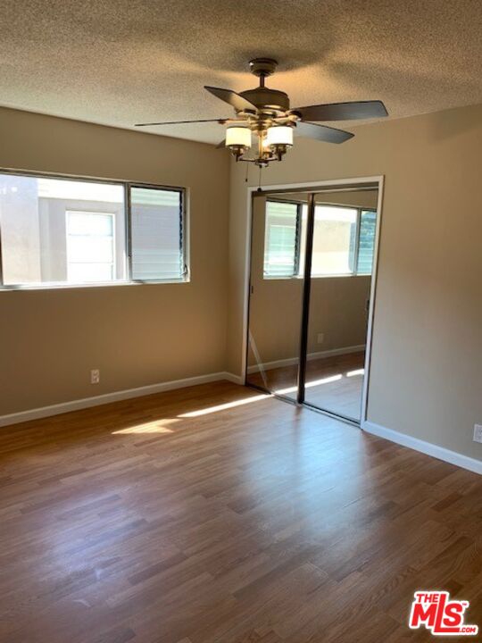 1201 South Sherbourne Drive, Unit 4 Los Angeles, CA 90035 - Photo 10 of 14 a view of an empty room with wooden floor and a window