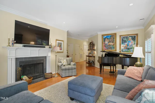 a living room with furniture a flat screen tv and a fireplace