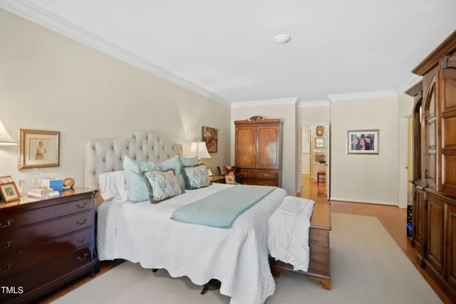 a bedroom with a bed and a dresser in it