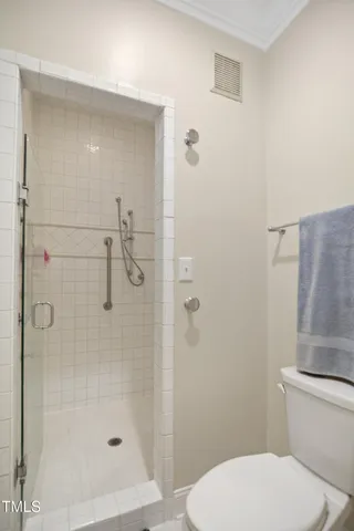 a bathroom with a toilet and a shower