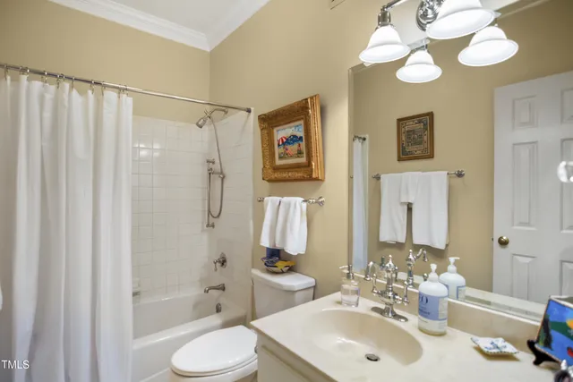 a bathroom with a sink toilet double vanity and shower