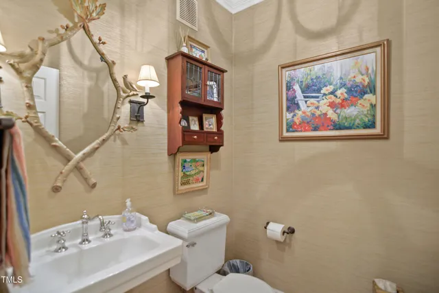 a bathroom with a sink mirror and toilet