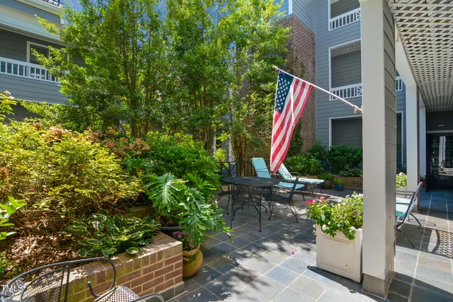 a view of house with backyard and sitting area