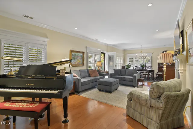 a living room with furniture and a piano