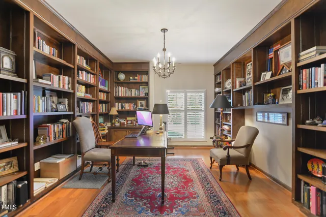a living room with furniture and a book shelf