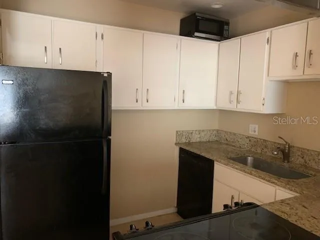 a kitchen with a sink and cabinets