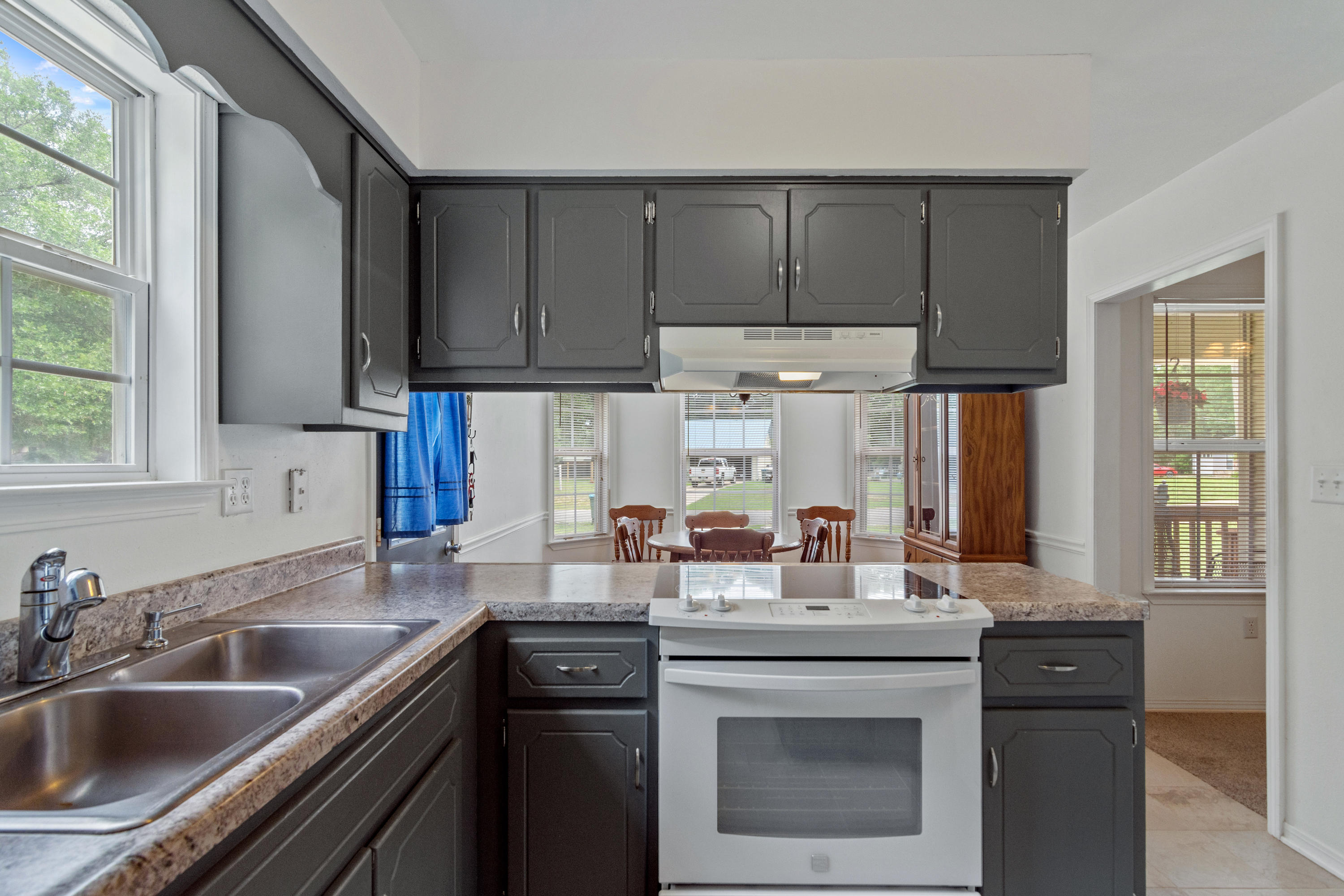 122 Springwood Circle Crestview, FL 32536 - Photo 11 of 27 a kitchen with stainless steel appliances granite countertop a sink stove and cabinets