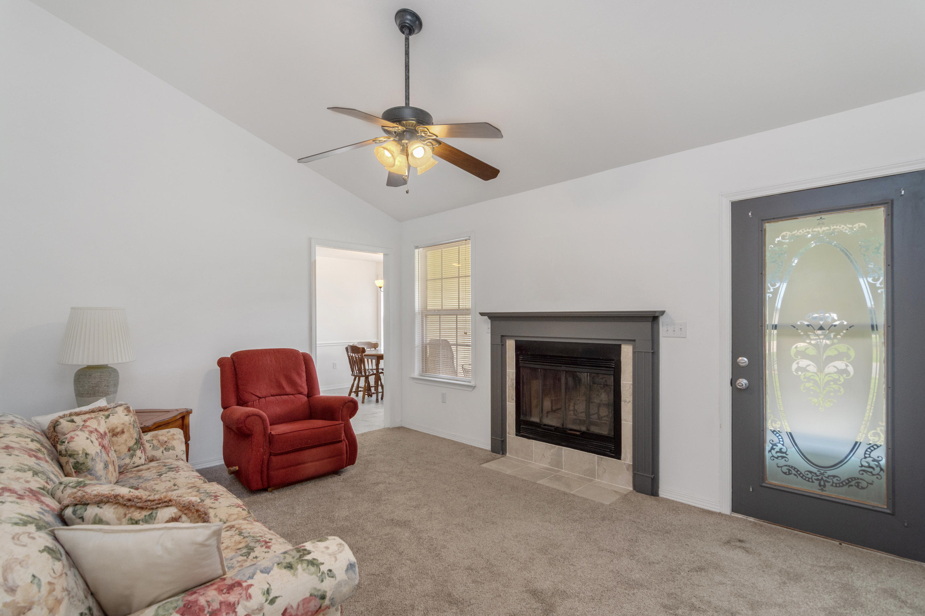 122 Springwood Circle Crestview, FL 32536 - Photo 5 of 27 a living room with furniture a ceiling fan and a window