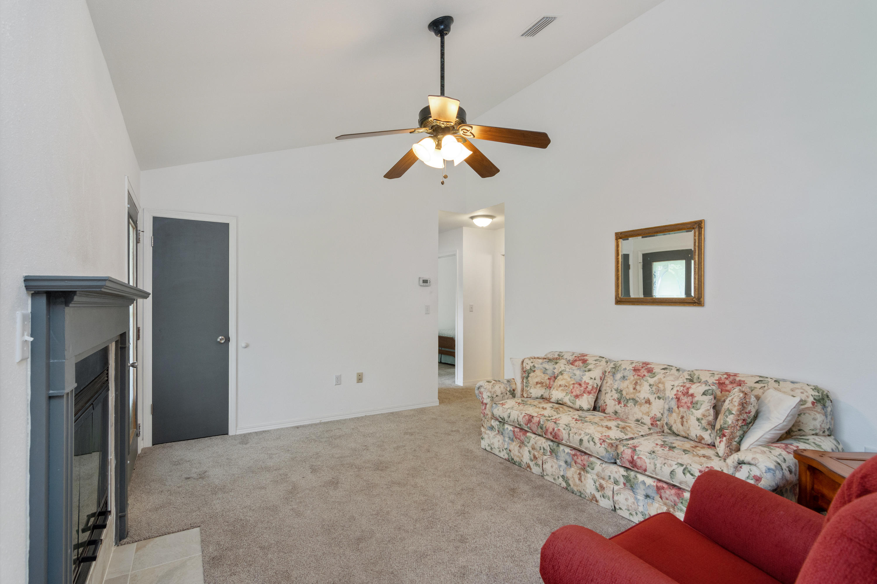 122 Springwood Circle Crestview, FL 32536 - Photo 6 of 27 a living room with furniture and a chandelier