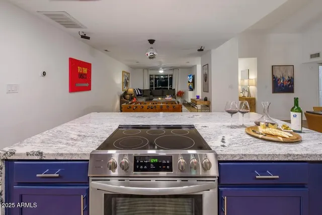 a kitchen with granite countertop a stove and a sink