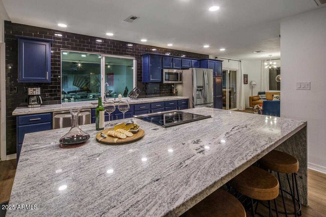 4526 East Paradise Lane Phoenix, AZ 85032 - Photo 13 of 48 a kitchen with stainless steel appliances granite countertop a sink and a refrigerator