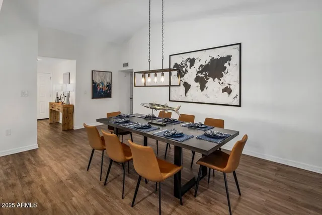 a view of a dining room with furniture and wooden floor