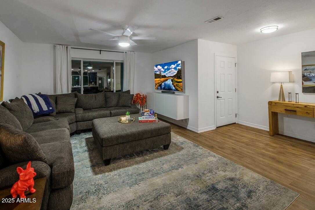 4526 East Paradise Lane Phoenix, AZ 85032 - Photo 19 of 48 a living room with furniture and a flat screen tv