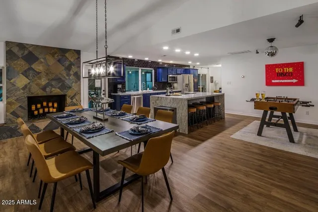 a view of a dining room with furniture a chandelier and wooden floor