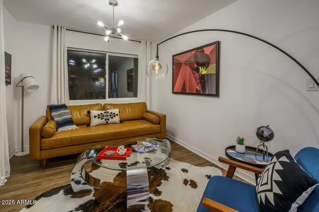 a living room with furniture and wooden floor