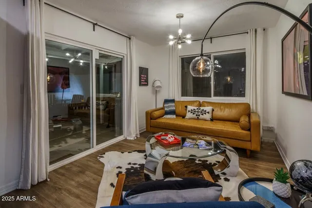 a living room with furniture and a chandelier