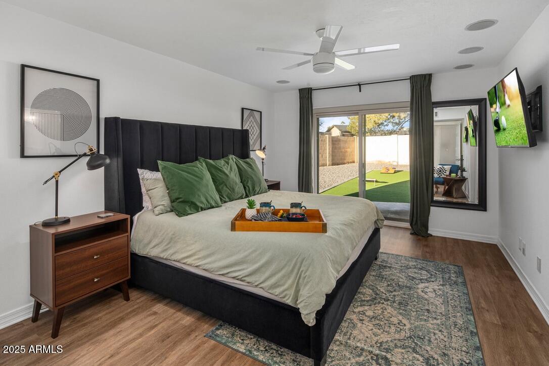 4526 East Paradise Lane Phoenix, AZ 85032 - Photo 24 of 48 a bedroom with a large bed and a flat tv screen on dresser