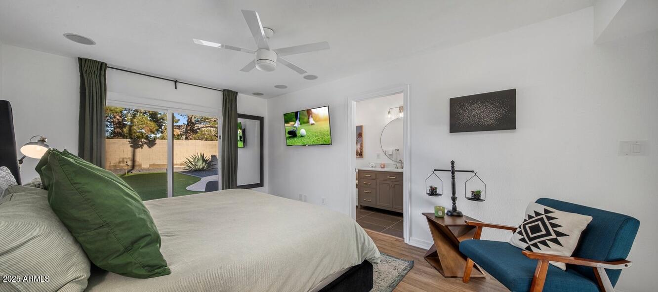 4526 East Paradise Lane Phoenix, AZ 85032 - Photo 25 of 48 a bedroom with a bed window and a flat screen tv