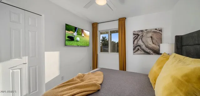 a bedroom with a bed and a chandelier