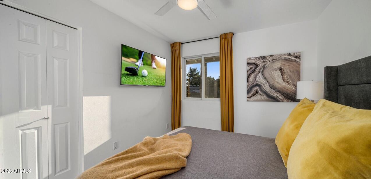 4526 East Paradise Lane Phoenix, AZ 85032 - Photo 28 of 48 a bedroom with a bed and a chandelier